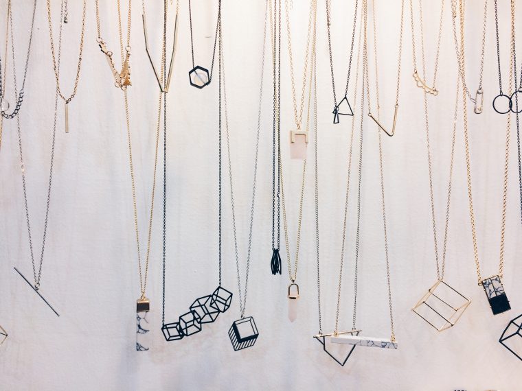 Minimalistic necklace jewelry hanged on the wall for the display